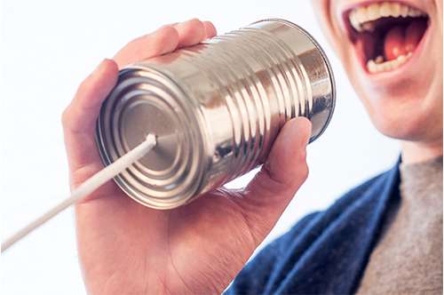 Man Holding Tin Can Telephone